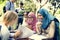 Diverse children studying outdoor together