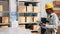 Diverse colleagues counting products on warehouse racks