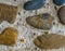 Diverse colored stones in different shapes with flint rocks in between in cement beautiful texture background