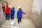 Diverse Community members painting a low cost house in Soweto
