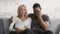 Diverse Couple Laughing Watching TV Eating Popcorn At Home