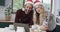 Diverse couple wearing santa hats using tablet for christmas video call, in slow motion