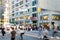 Diverse crowds of people walk through the crowded intersection on 14th Street at Union Square Park, New York City