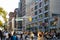 Diverse crowds of people walk through the crowded intersection on 14th Street at Union Square Park in New York City