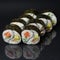 Diverse delicious sushi roll set on a black background with reflection, menu