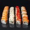 Diverse delicious sushi roll set on a black background with reflection, menu