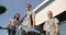 Diverse doctors in uniforms stand outdoors at the hospital entrance