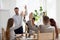 Diverse employees raise hands involved in teambuilding activity