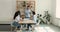 Diverse employees sit at desk listen team leader at meeting