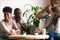 Diverse excited friends having fun together in cafe