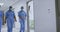 Diverse female surgeons wearing face masks walking in hospital corridor