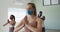 Diverse fit people wearing face masks performing yoga in yoga studio
