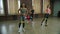 Diverse fit women doing banded standing leg abductions