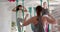 Diverse fitness teenage girls in aerial yoga class with female coach in big white room, slow motion