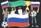 Diverse football fans holding the flag of Russia