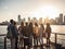 Diverse friends enjoying cityscape on pier