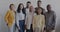 Diverse group of businesspeople standing against office background smiling posing for corporate portrait