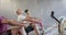 Diverse group fitness class training hard on rowing machines at gym, in slow motion