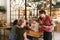 Diverse group of girlfriends ordering drinks from a bistro waiter