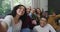 Diverse group of happy male and female friends smiling and taking selfie in living room