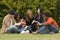 Diverse group of people reading and studying.