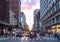 Diverse group of people walking across a busy intersection in New York City