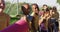 Diverse group of schoolchildren standing holding mats before yoga lesson outdoors