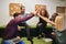 Diverse group of smiling designers high fiving in an office