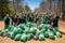 Diverse group of young volunteers engaged in outdoor garbage cleaning and waste separation project