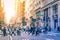 Diverse groups of people walk across the crowded intersection of Broadway and Spring Street in the SoHo neighborhood of Manhattan