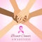 Diverse hands joining for breast cancer awareness