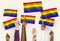 Diverse hands waving rainbow flags