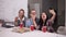 Diverse happy coworkers eating pizza during break in office and taking selfie happily all together. Modern, bright