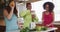 Diverse happy female friends trying healthy drinks at home