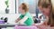 Diverse happy schoolchildren sitting at desks in school classroom