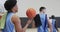 Diverse male basketball team training in indoor court, in slow motion