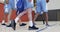 Diverse male basketball team training in indoor court, in slow motion