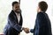 Diverse male colleagues handshake get acquainted at meeting