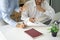 Diverse male mentor and intern talking pointing on paper