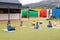 Diverse male teacher and elementary schoolchildren practicing meditation in schoolyard