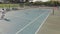 Diverse male tennis players holding rackets and playing tennis at court