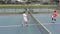 Diverse male tennis players holding rackets and playing tennis at court