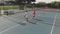 Diverse male tennis players holding rackets and shaking hands at court