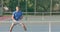 Diverse male tennis players playing on outdoor tennis court in slow motion