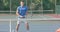 Diverse male tennis players playing on outdoor tennis court in slow motion