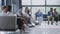 Diverse multicultural people sit on couches in clinic lobby area