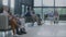 Diverse multiethnic people sit on couches in clinic lobby area