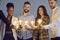 Diverse multinational group of people hold lightbulb together studio shot