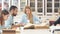 Diverse multiracial students spending leisure time in library with big old book