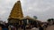 Diverse multitude of individuals converges around a splendid golden sculpture: Chamundeswari Temple